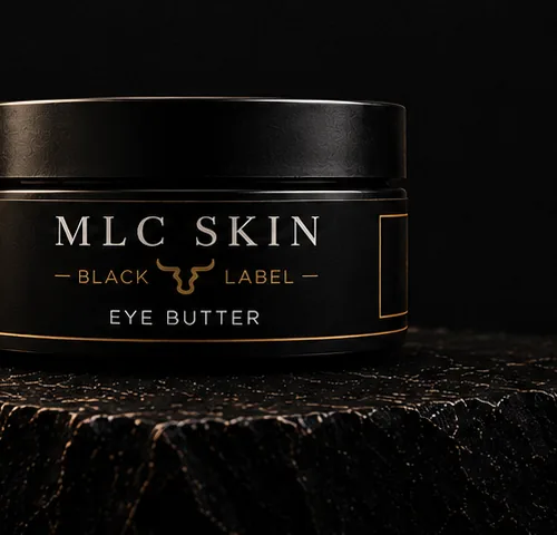 MLC Skin Black Label Eye Butter jar resting on a dark wood surface.